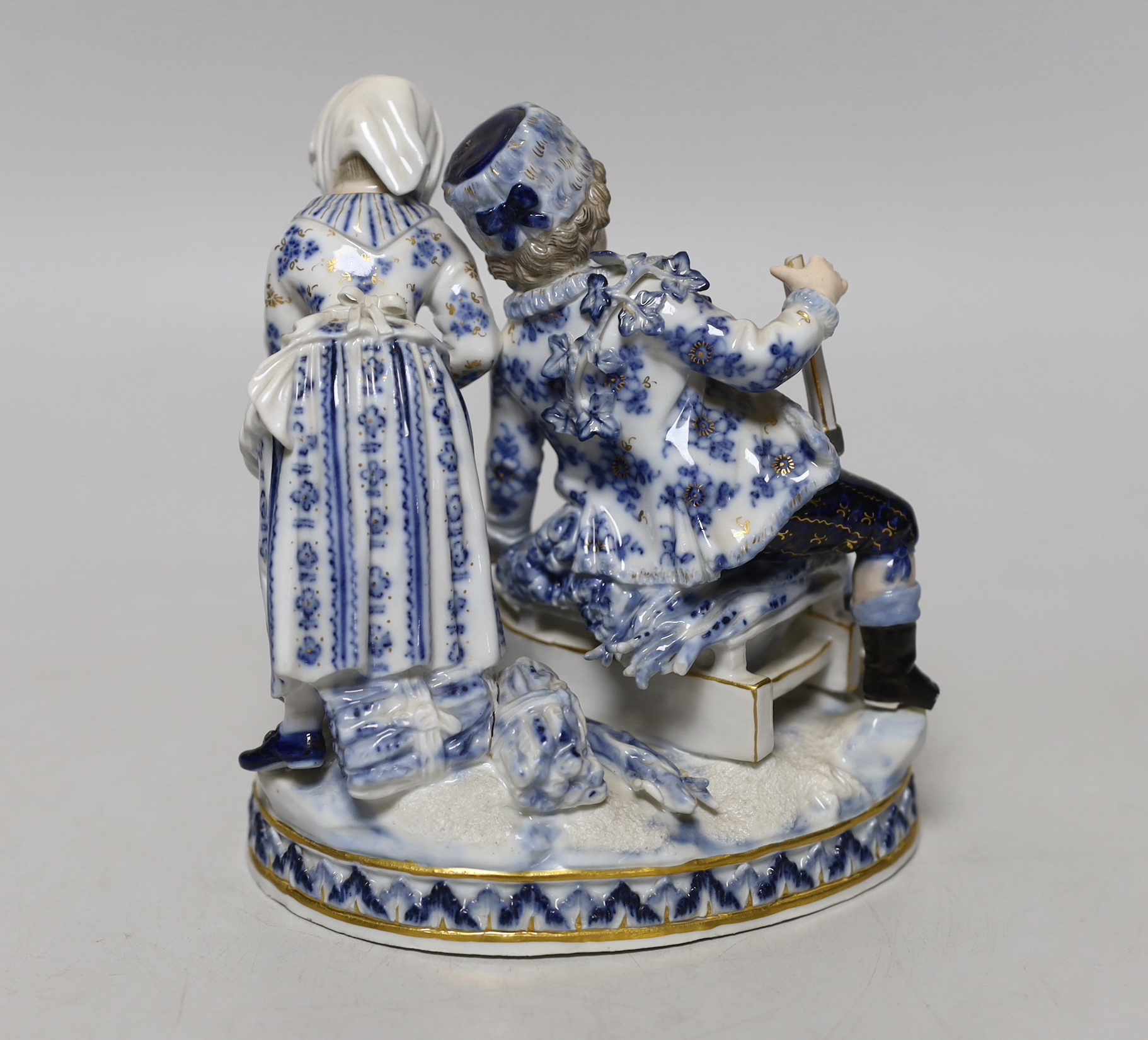 A Meissen blue and white figural group, 15cm high